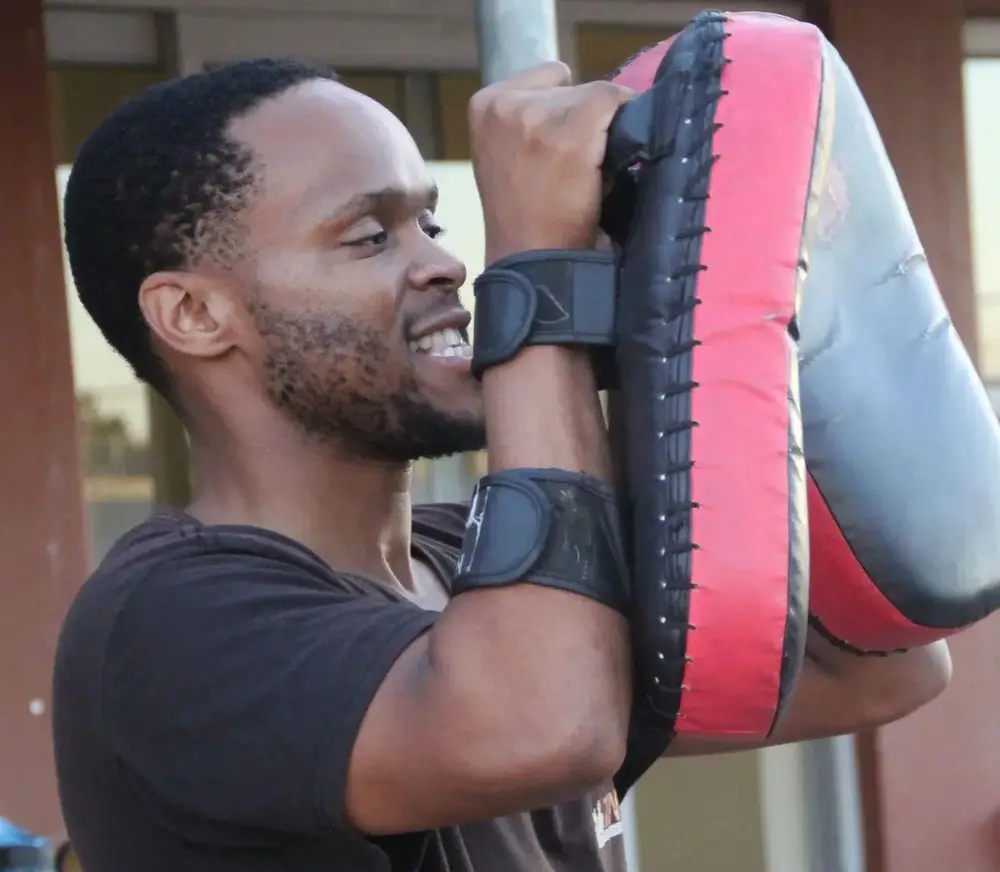 Coach Yams holding pads